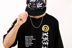 Close-up of stainless steel keel chain necklace worn with a black graphic print T-shirt