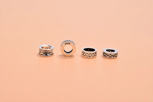 Detailed macro view of S925 sterling silver spacer beads with vintage engraved patterns