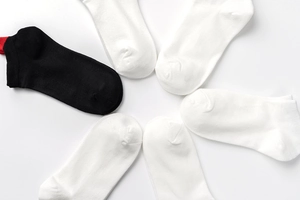 Detail view of cotton low cut ankle socks in a pack of six black and white pairs