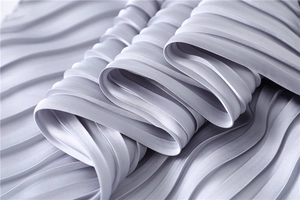 Macro shot of pleated satin fabric texture in lavender with silky glossy finish