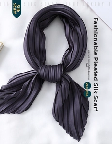 Detail of pleated silk-like scarf showing deep purple texture and elegant folds