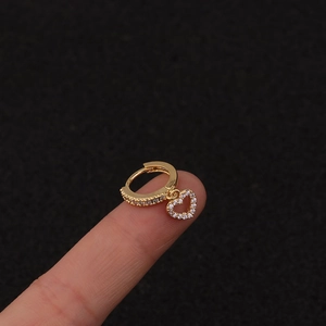 Detailed view of a gold lightning bolt earring with sparkling cubic zirconia on a hand