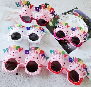 Funny cupcake party glasses in various colors with Happy Birthday text on white background