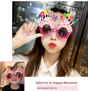 Close-up of pink cupcake birthday party glasses with colorful Happy Birthday lettering