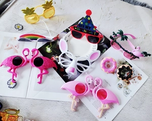 Detailed close-up of colorful plastic novelty party glasses including pineapple and flamingo