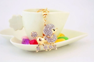 Detail of a gold poodle keychain with sparkling clear crystals and elegant clasp