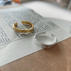 Detailed macro view of S925 sterling silver hammered rings in gold and silver finish