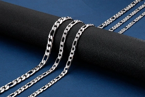 Detail view of 9mm stainless steel NK curb chains wrapped on a black display stand