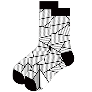 Detailed view of black and white geometric pattern socks with abstract line design