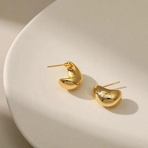 Minimalist 18K gold plated bean stud earrings with polished drop shape on white tray