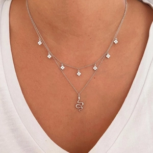 Double-layered S925 silver necklace with snake pendant and clover charms on model