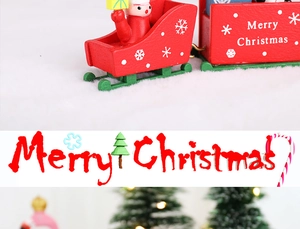 Detailed view of red and green wooden Christmas train ornaments with painted finish