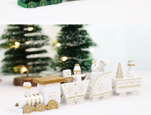 Detail of four-section wooden Christmas train with gold snowflakes on snowy background