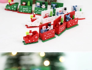 Detail of wooden Christmas train featuring hand-painted Santa and snowman figurines