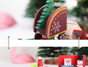 Macro detail of wooden Christmas train featuring mini snowman and festive trees
