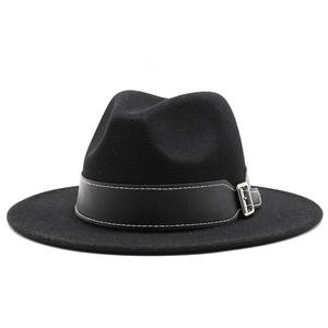 Detail of black wool fedora with leather band, white stitching and silver metal buckle