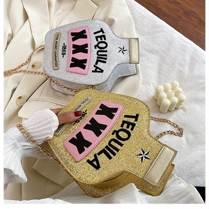Close-up of creative wine bottle crossbody bag with laser sequins and gold chain strap