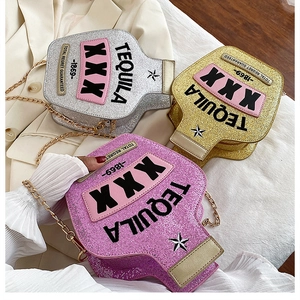 Detail of glitter wine bottle crossbody bags with gold chain and Tequila embroidery