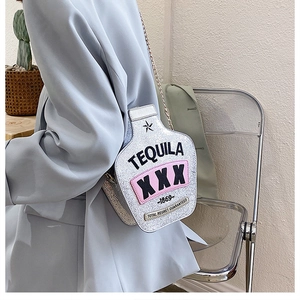 Fashionable silver tequila bottle shoulder bag with laser sequins on a grey blazer outfit