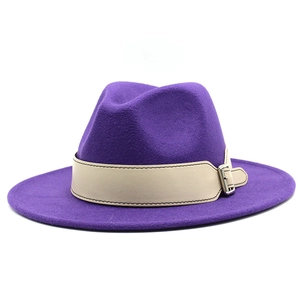 Close-up of a purple wool fedora hat with a beige decorative belt and silver buckle