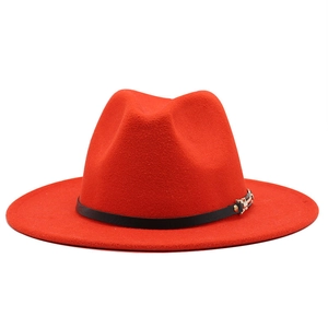 Detailed view of the red wool fedora hat featuring a thin black belt with a metal buckle