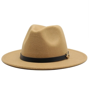 Detail of camel wool fedora hat featuring a black leather band and gold metal buckle