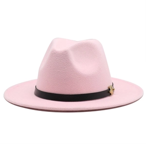 Detail of pink wool fedora hat featuring black leather band and gold metal buckle