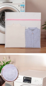 Detail of 3D cylindrical laundry mesh bag with pink zipper for protecting delicate clothes