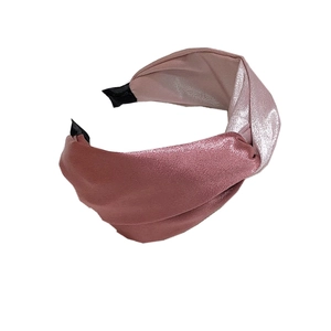 Pink satin wide headband with elegant twisted knot design on clean white background