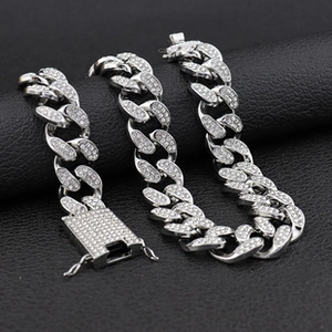 Macro shot of 20mm Cuban link necklace featuring iced-out rhinestones and box clasp detail
