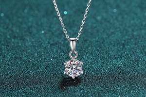 Detail of 1ct moissanite pendant with classic six-prong setting on silver chain