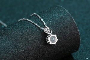 Macro shot of 1-carat moissanite silver pendant showing detailed six-prong setting