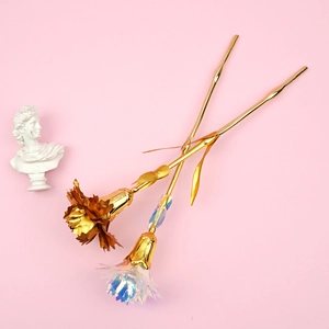 Detail showing artificial carnations in bronze and holographic tones on pink background