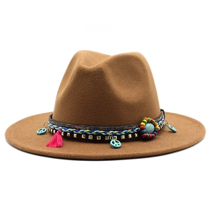 Detail of wool fedora with ethnic woven band, turquoise peace charms and pink tassels