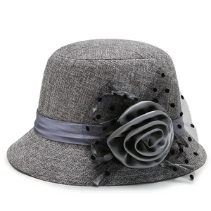 Elegant grey woven cloche hat with a large satin rose and black polka dot mesh veil