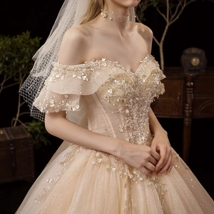 Champagne off-shoulder bridal gown with luxury beaded lace and shimmering tulle skirt