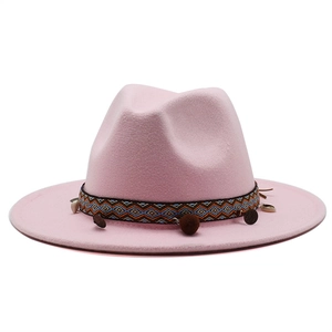 Pink wool fedora hat with ethnic woven band featuring pom-poms, shells and metal coins