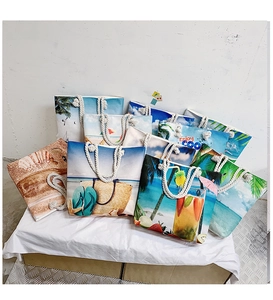 Detail of canvas beach bags with nautical prints and white cotton rope handles