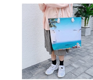 Detail of beach canvas tote featuring nautical scenery prints and soft cotton rope handles