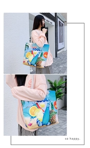 Detail of canvas beach tote featuring Enjoy COOL summer print and soft rope handles