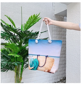 Detail of canvas beach tote with tropical print and thick white cotton rope handles
