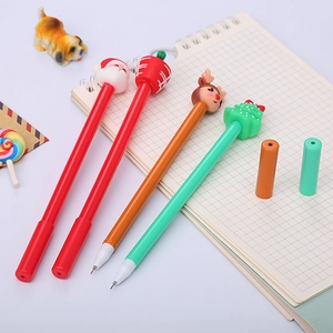 Christmas themed cartoon gel pens featuring Santa and reindeer on a grid notebook