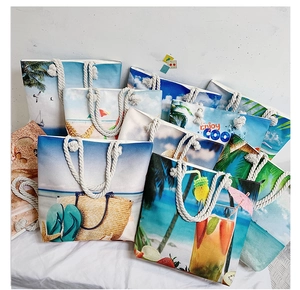 Group view of printed canvas beach tote bags with tropical prints and rope handles