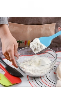 Blue seamless silicone spatula scooping flour during baking with heat-resistant tools