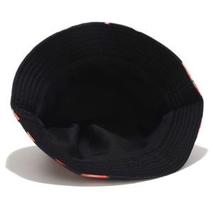 Detail of the dark blue bucket hat featuring fruit patterns and black fabric lining