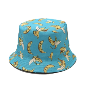 Close-up of blue bucket hat featuring realistic banana patterns and canvas fabric texture