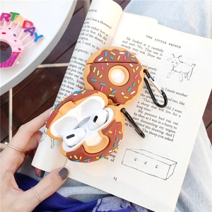 Detail of doughnut silicone case with hook for AirPods on The Little Prince book background