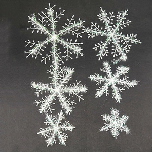 Macro shot of six assorted white snowflake ornaments with glitter for Christmas tree decor