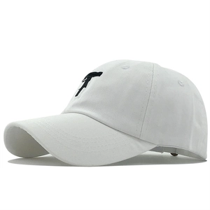 White cotton baseball cap with black pistol embroidery shown from a 45-degree side angle