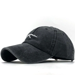 Vintage black washed cotton baseball cap featuring white rifle embroidery in 45-degree view